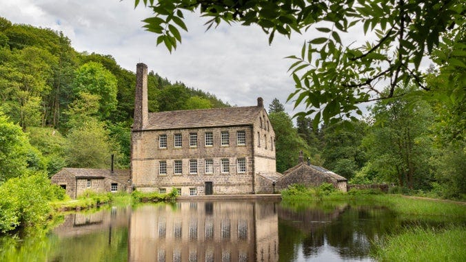 Gibson Mill and its large chimney, also reflected in the water beside it, at Hardcastle Crags, West Yorkshire