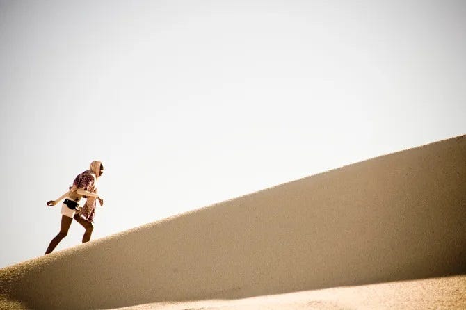 Still from Pumzi: Asha climbing a dune