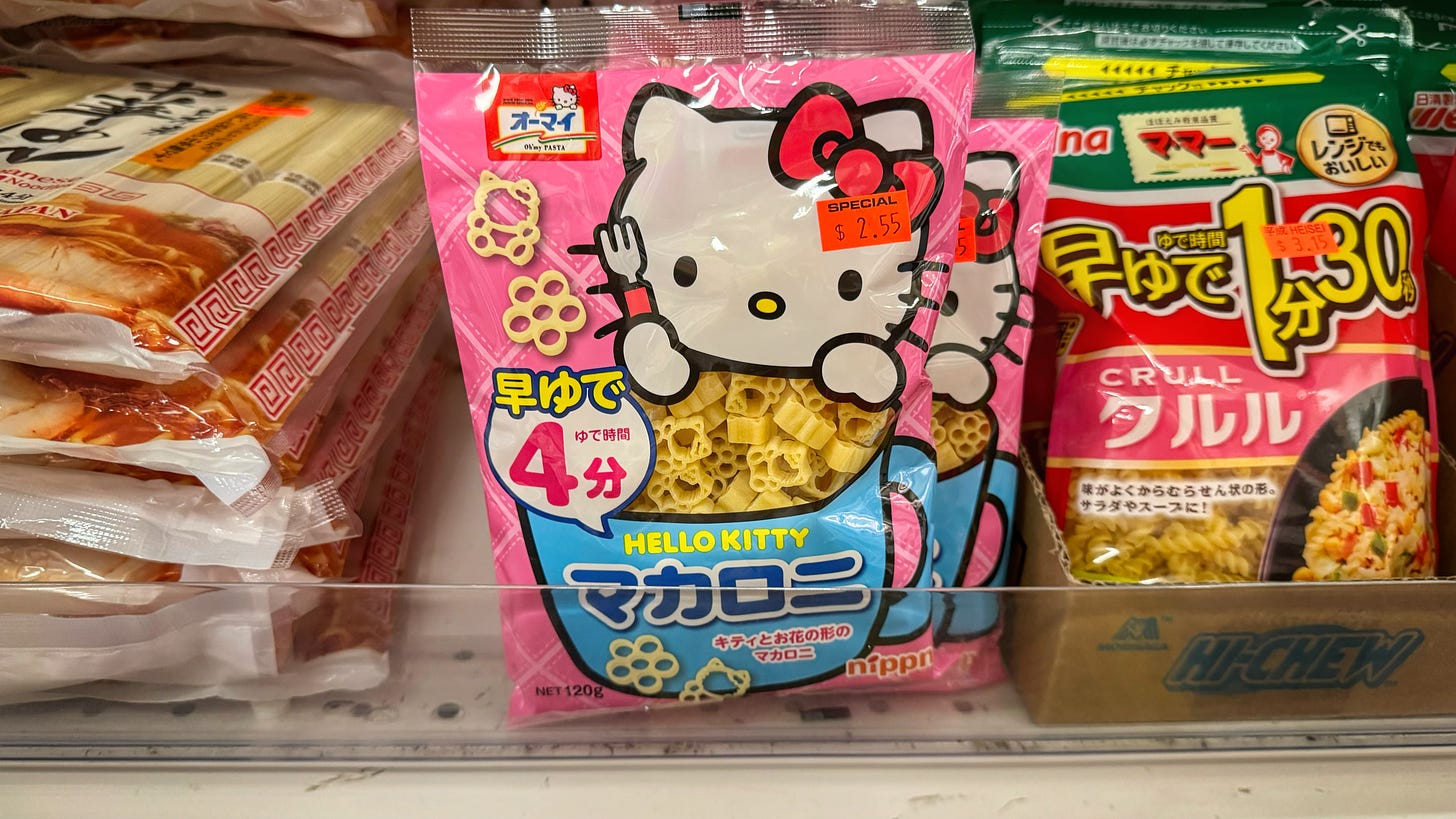 A package of Hello Kitty! macaroni on a store shelf at Heisei Mart. Its price tag reads $2.55. It is beside a package of Crull pasta that is priced at $3.15.