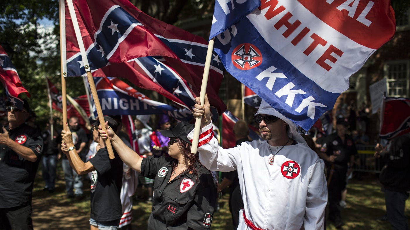 White supremacists wave confederate flags and KKK banners in Charlottsville riot