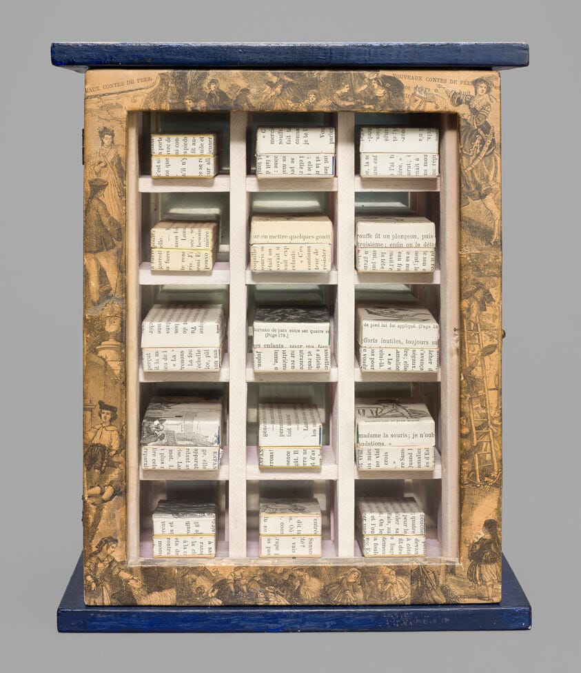 A Joseph Cornell box construction with a grid of 15 small compartments. Each compartment contains a paper box made from the pages of a French book. The frame around the compartments is decoupaged with sepia-toned illustrations of figures in European historical dress. 