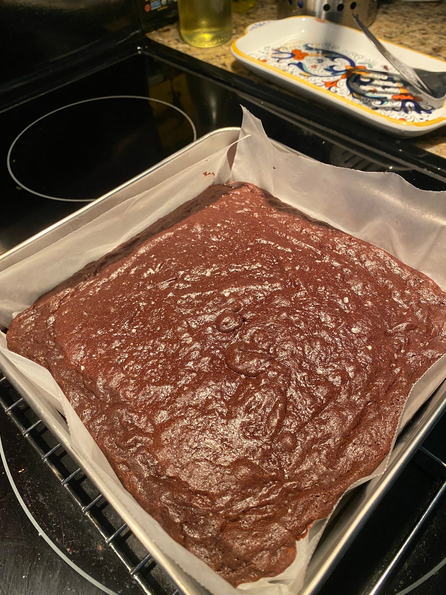 A pan of brownies on a cooling rack on top of the stove.