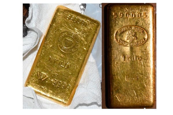Two gold bars with “one kilo” engraved in them.
