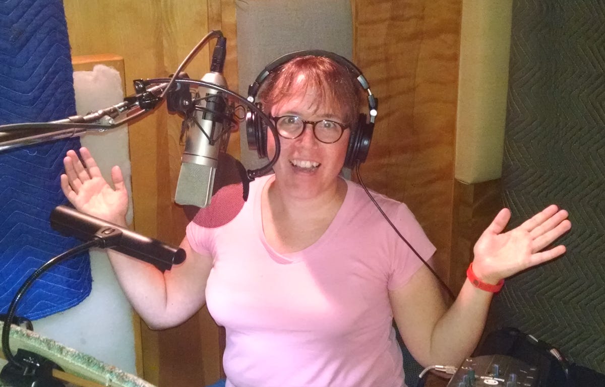 photo of the author in front of a microphone in a recording studio