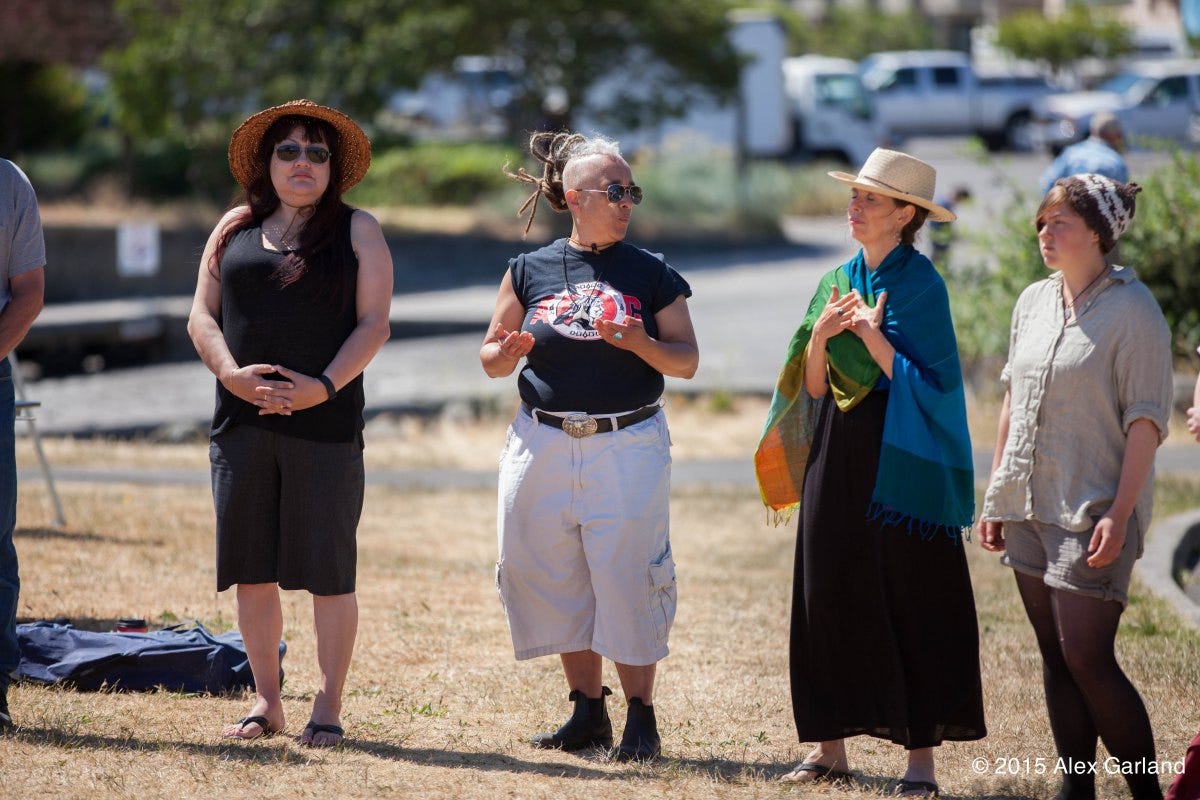 diverse circle stand and speak in a park