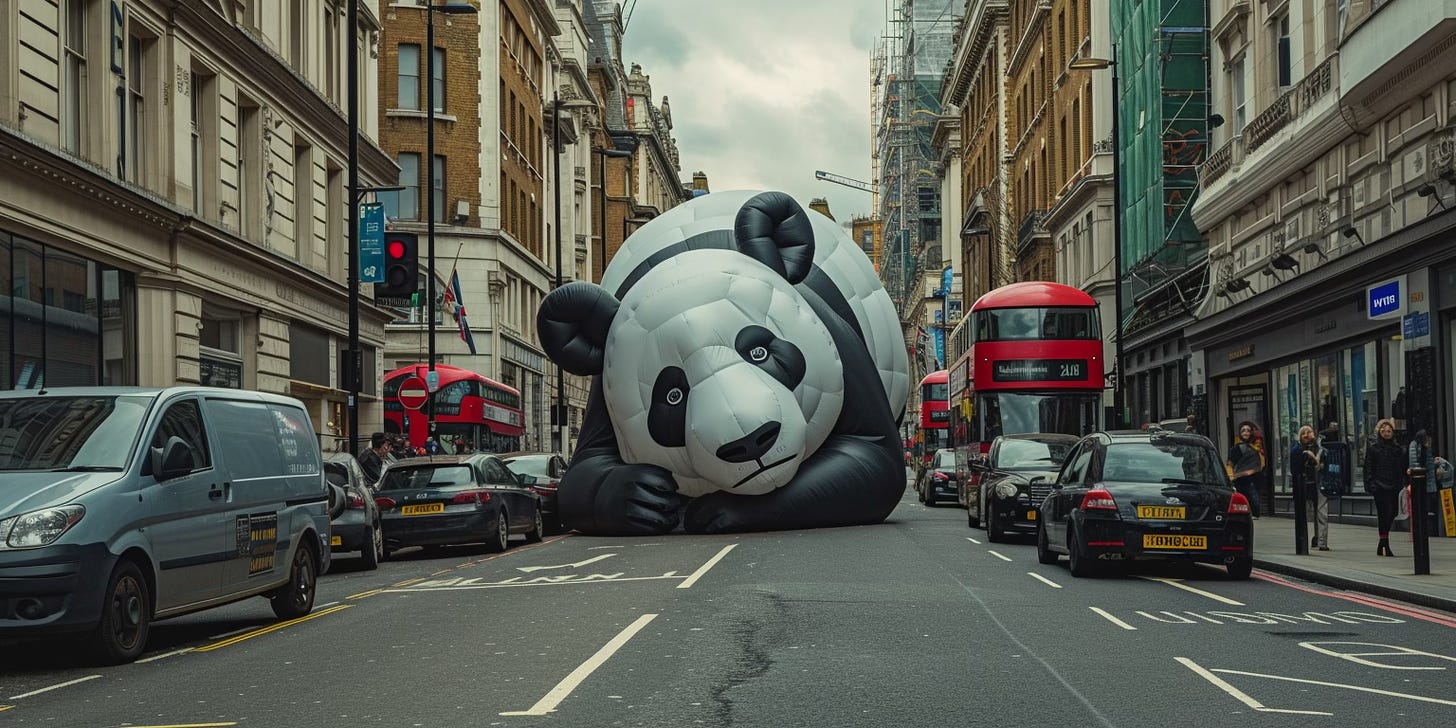 a large inflatable panda in the middle of a London street