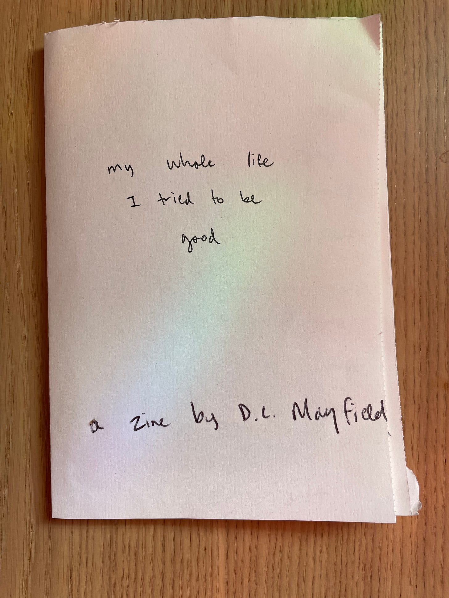 small white booklet in handwriting it says my whole life I tried to be good a zine by d.l. mayfield