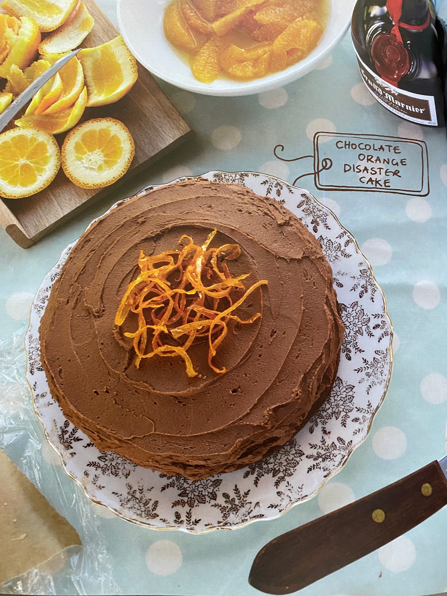 Chocolate cake with orange zest decoration on a decorative plate.