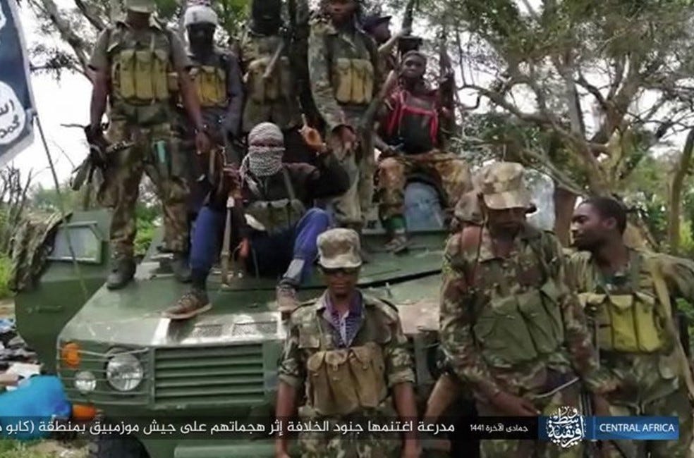 Terrorists sit on top of armoured vehicle