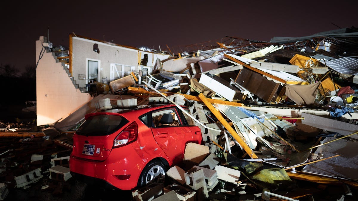 A car is buried under rubble on Main Street after a tornado hit Hendersonville, Tenn., Saturday, Dec. 9, 2023.
