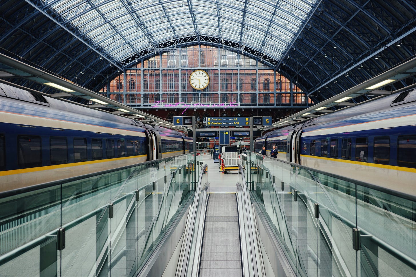 Two Eurostar trais at St Pancras with escalator in the middle