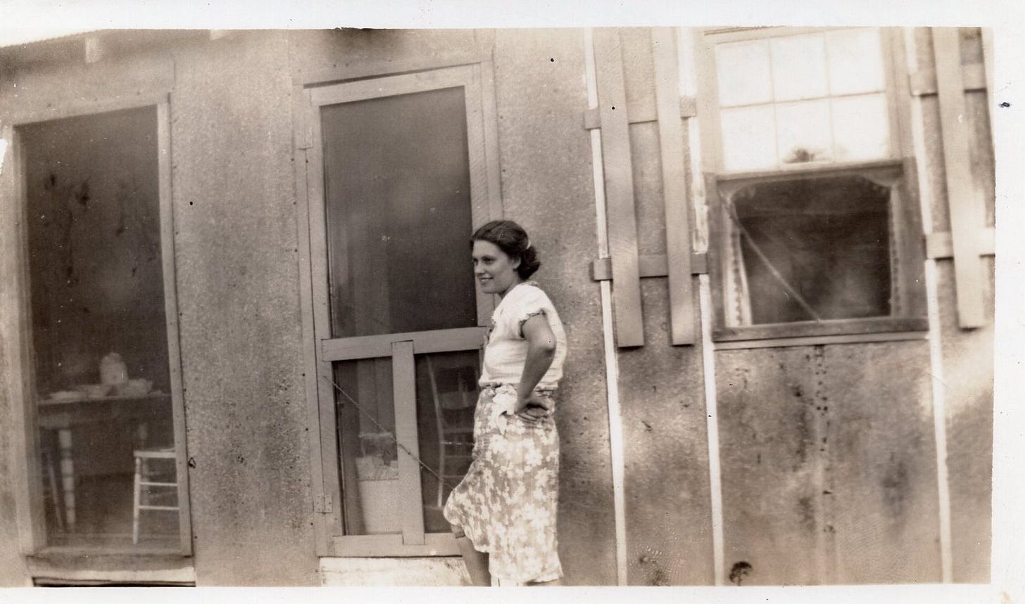 Expectant mother stands outside of a cabin in Spring 1939 Expectant mother stands outside of a cabin in Spring 1939