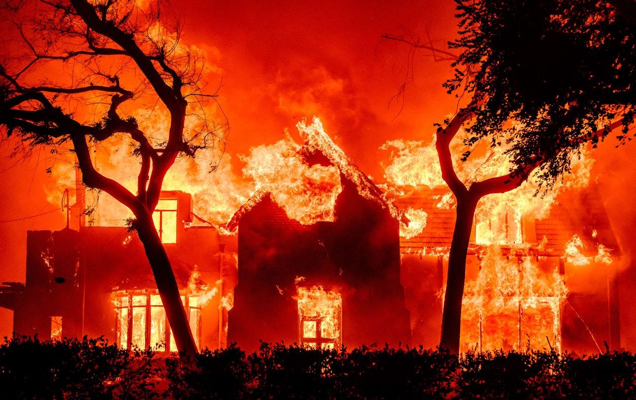 A home is engulfed in flames by the Eaton Fire in Altadena on Wednesday.