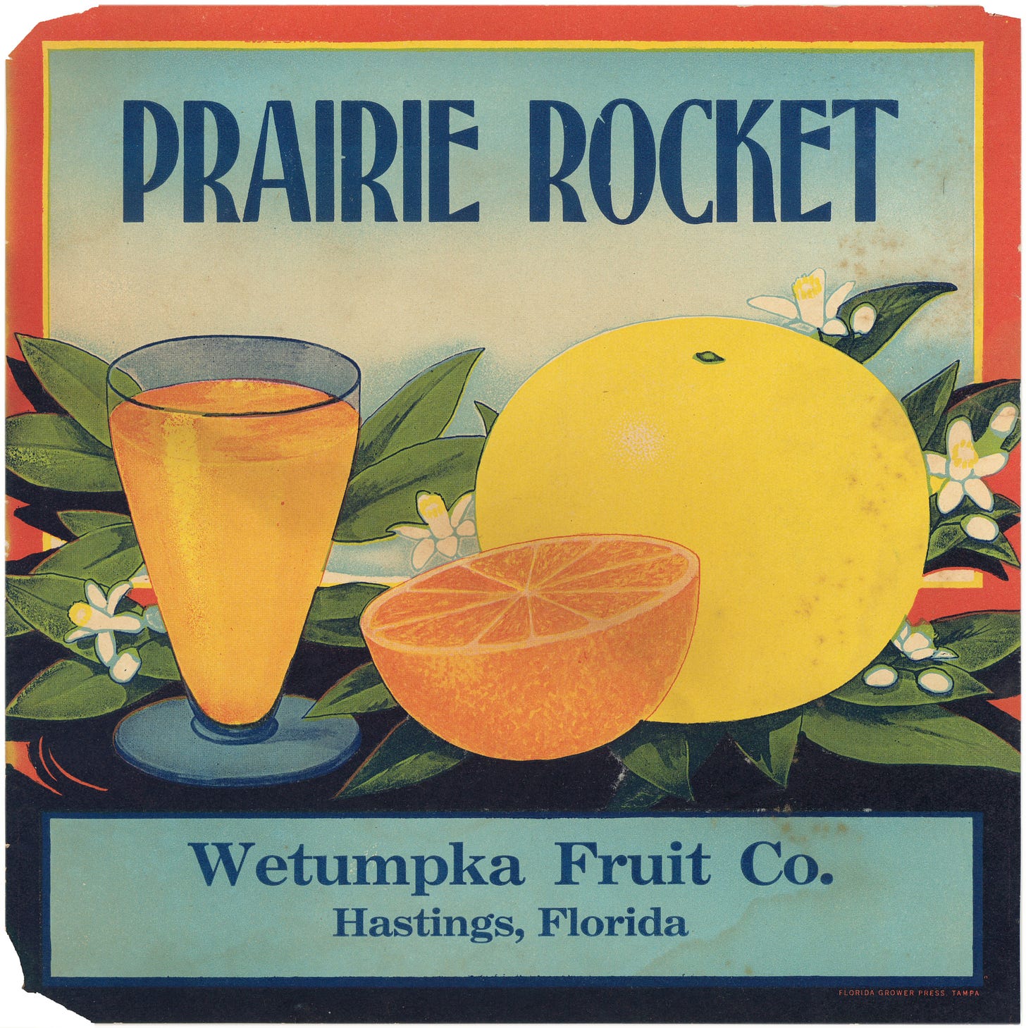 Glass of grapefruit juice with blue letters that say Prairie Rocket.