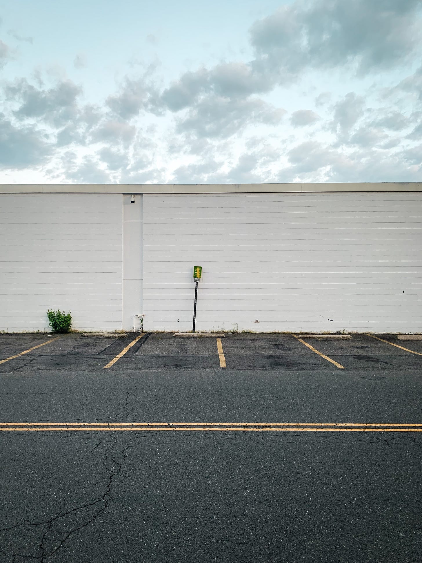 empty parking lot with a cloudy sky above