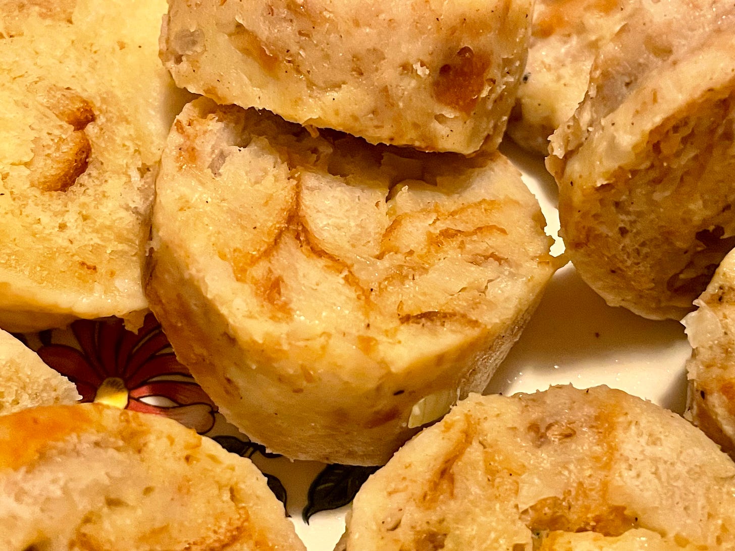 Close-up of slices of bread dumplings with a soft and tender texture, arranged on a plate. Close-up of slices of bread dumplings with a soft and tender texture, arranged on a plate.