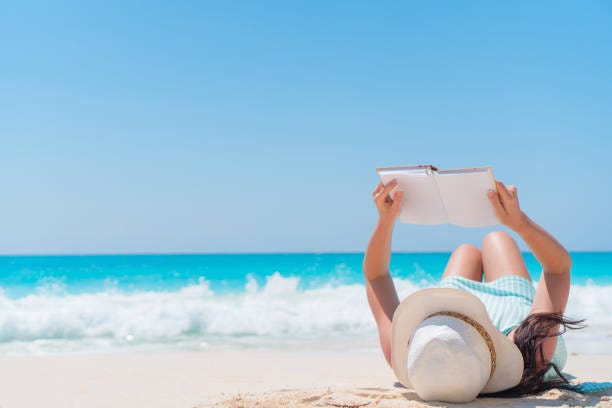 50+ Young Woman Reading A Book At The Caribbean Beach Stock Photos,  Pictures & Royalty-Free Images - iStock