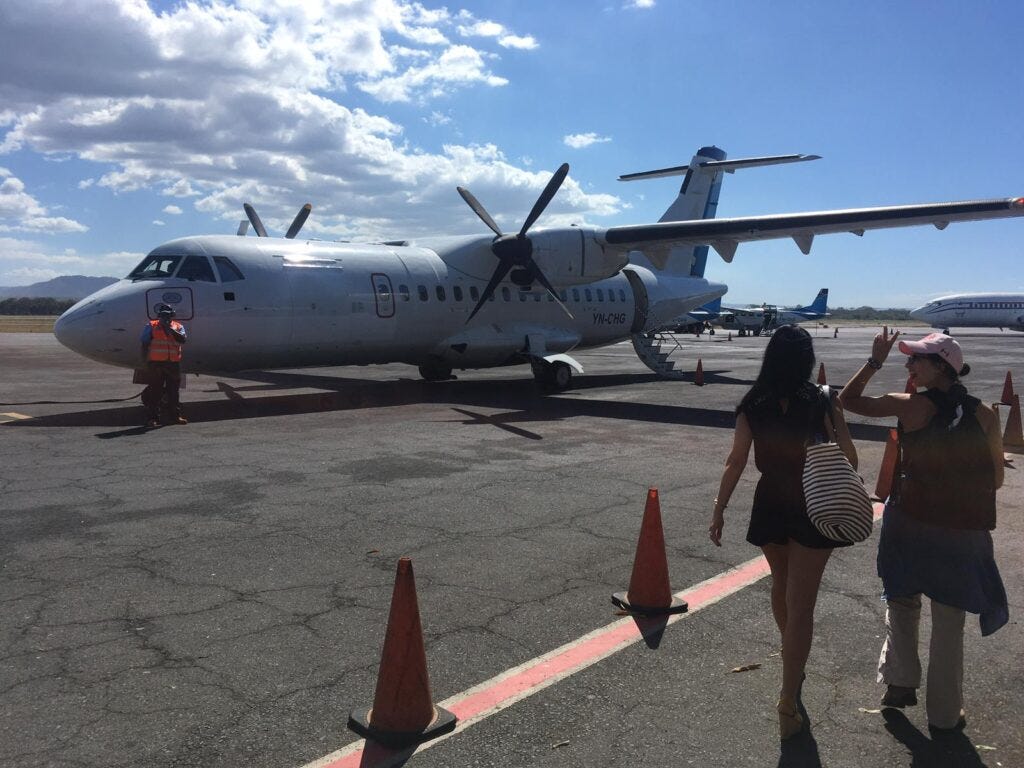 two women getting on airplane