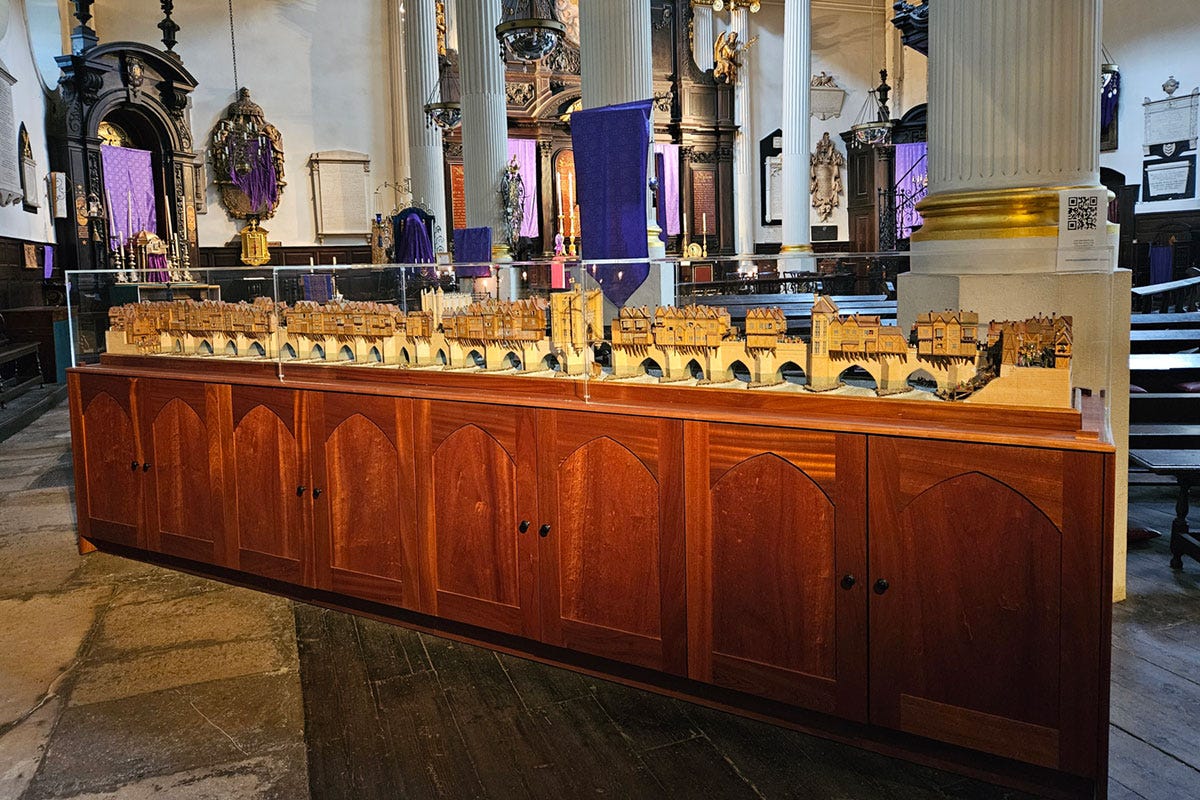 A large display case behind church pews