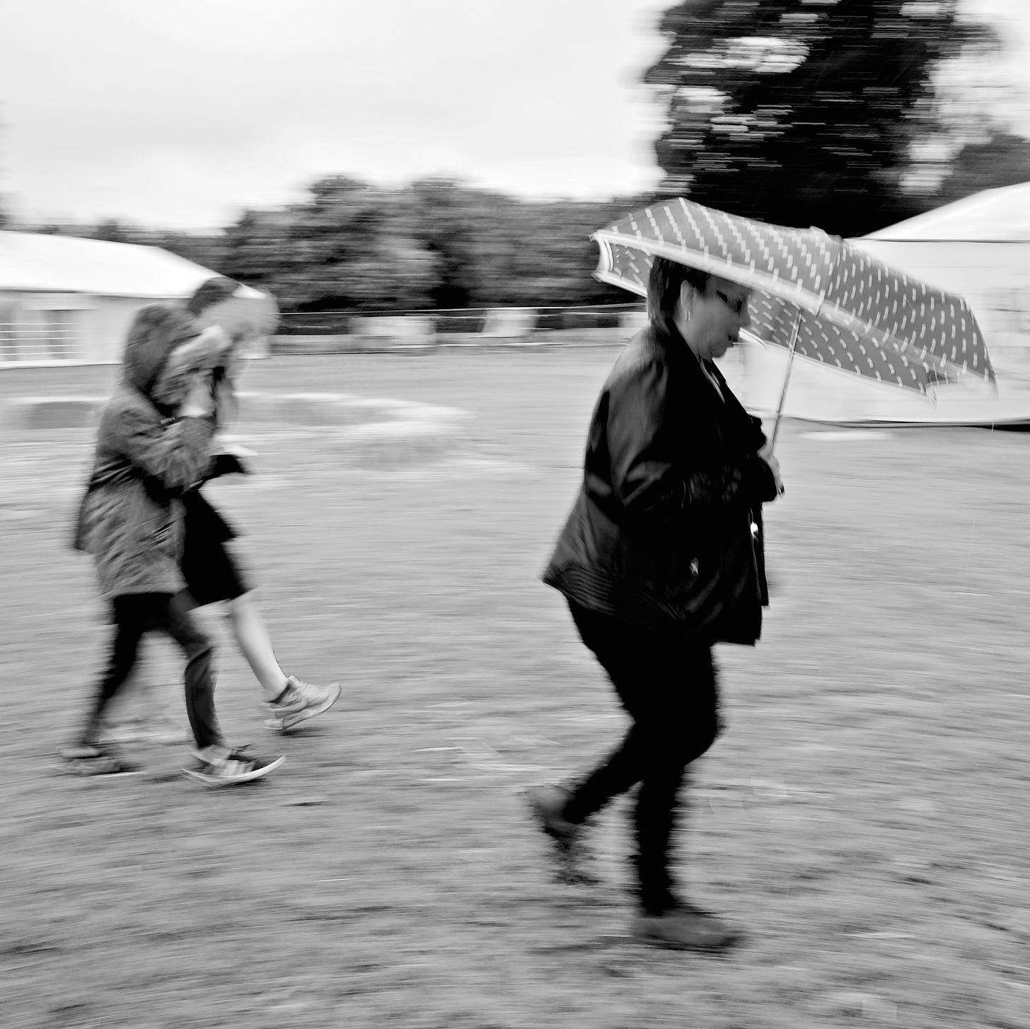Visitors to The Big Malarkey Festival, Hull’s renowned children’s literature event, scurry from tent to tent in the rain, 2017. © Jerome Whittingham