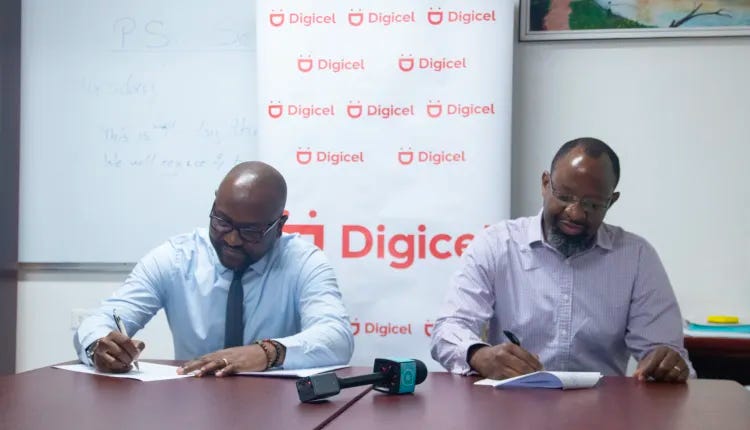 Digicel Guyana and Ministry of Health leadership putting pen to paper, solidifying their agreement