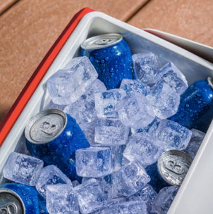 A photo of a cooler full of ice and blue cans