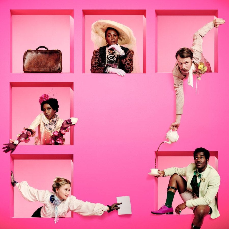 Five people in colorful vintage attire are framed within pink square cutouts against a bright pink background. They each pose differently, showcasing their unique outfits, which feature eccentric accessories like a large hat, pearls, and floral embellishments.