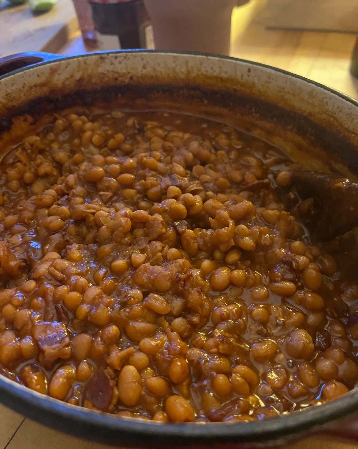 A pot of baked beans. You can see they've baked a good long time, as there's a good layer of sauce baked against the ridge of the pot