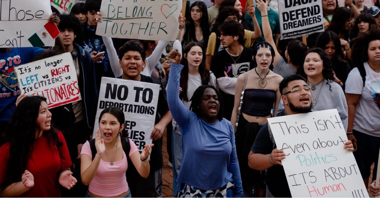 A group of people protesting

AI-generated content may be incorrect.