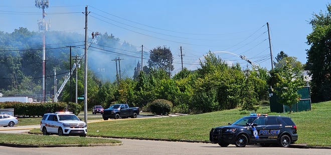 Emergency response vehicles block off the area surrounding a Rosemary Boulevard fire on Thursday in East Akron.