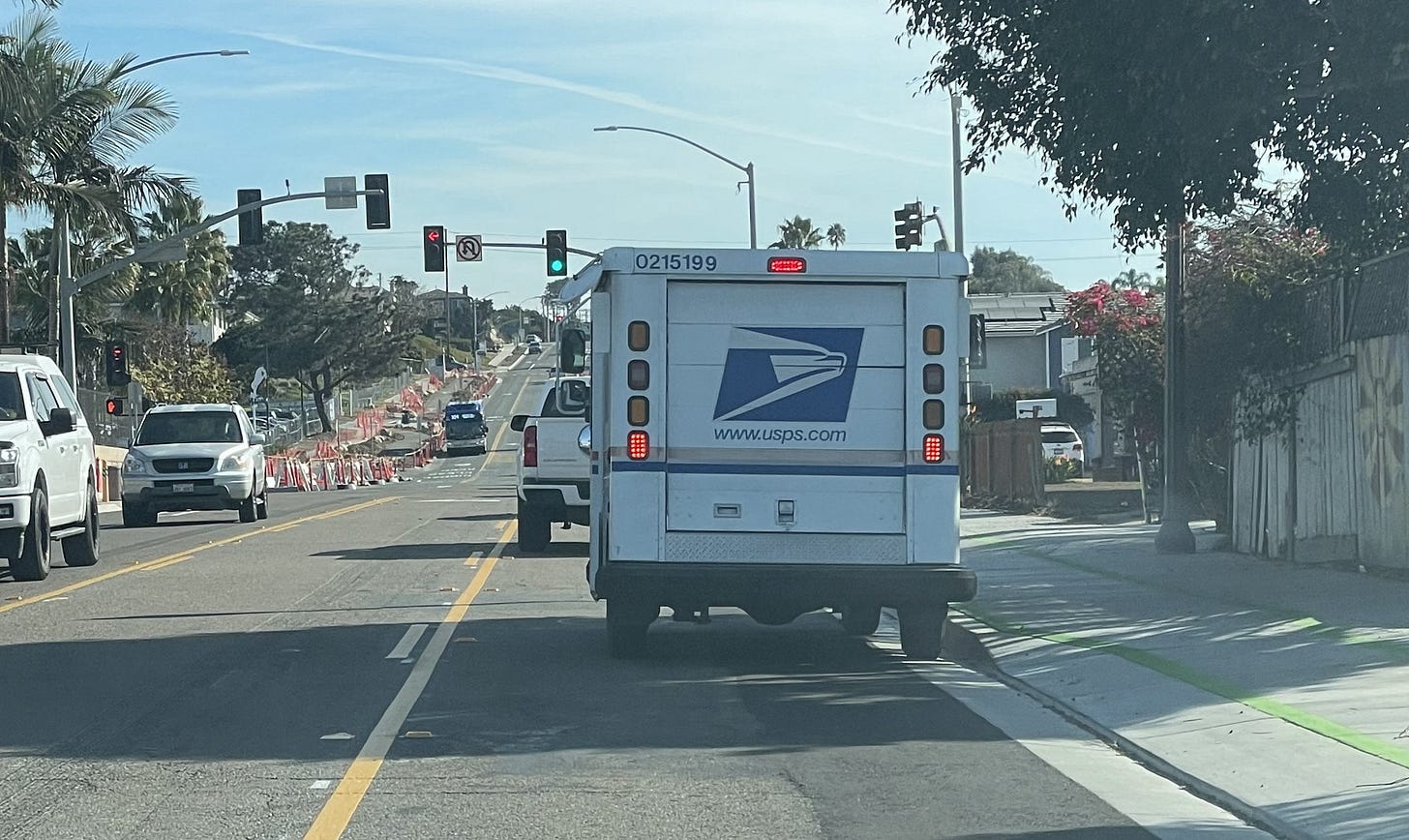 A U.S. Postal Service carrier had to stop in the middle of the eastbound lane on Santa Fe Drive in Encinitas to deliver mail several weeks ago. The post office has suspended mail carriers from delivering mail due to safety concerns on the road. Steve Puterski photo