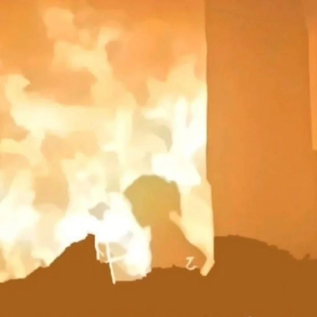 The silhouette of a young girl illuminated by flames as she flees a school bombed by the IDF in Gaza. The silhouette of a young girl illuminated by flames as she flees a school bombed by the IDF in Gaza.