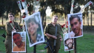 Israeli soldiers pay their respects at memorials to those killed in the Hamas terrorist raid on the Supernova music festival