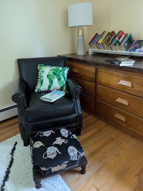 chair with ottoman and books