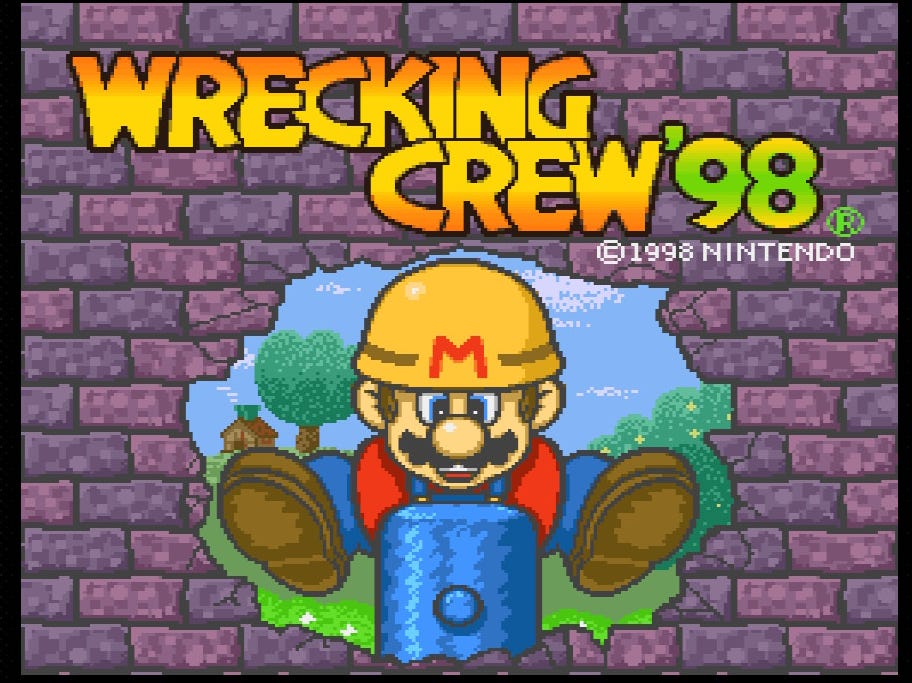 A screenshot of the title screen of Wrecking Crew '98, which has Mario in his traditional blue overalls and red shirt, with the yellow construction helmet you likely know better from Super Mario Marker, wielding a hammer that he used to burst through a purple brick wall.