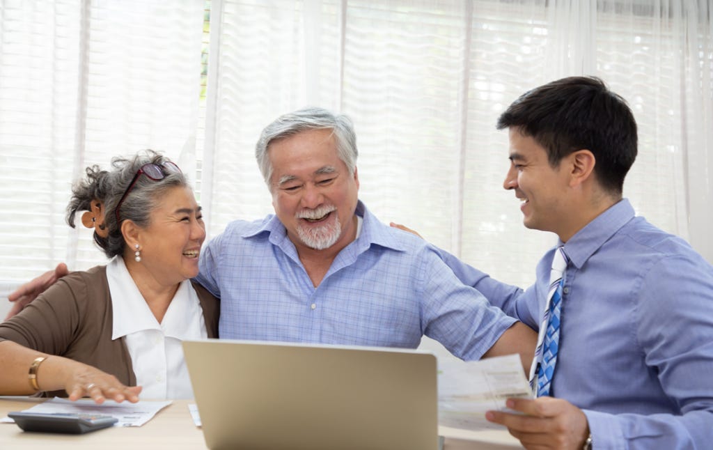 Eldery couple meeting with Financial Advisor to review return on investment