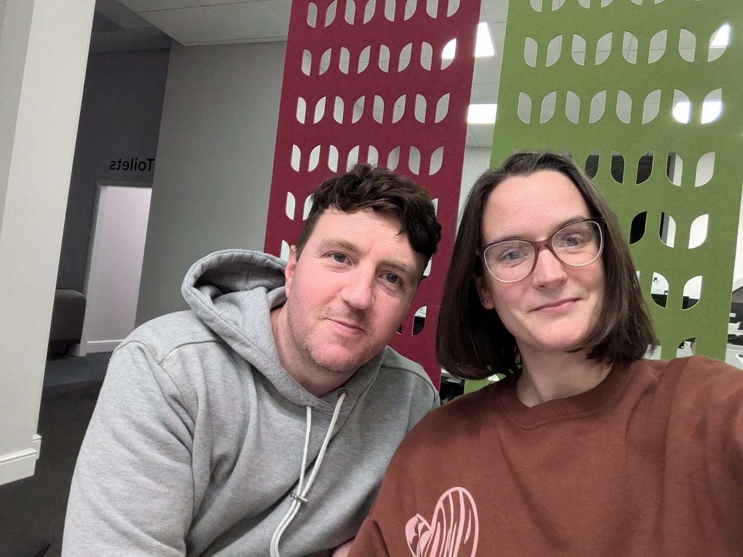 Ben and Mel in front of some audio soundproofy felt things