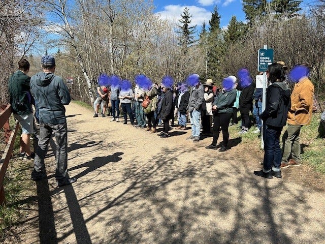 about 40 people listen to someone present ideas about 76 Avenue on a Jane's Walk in Edmonton, AB