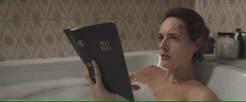GIF of Fleabag reading the Bible in the bathtub.