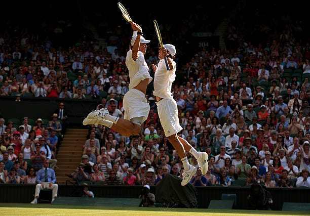 Mike Bryan and Bob Bryan of the United States of America bump chests as they celebrate match point during their Gentlemen's Doubles final match...