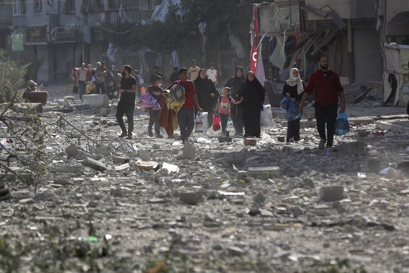 Palestinians leave their homes following Israeli bombardment on Gaza City, Monday, Oct. 30, 2023.