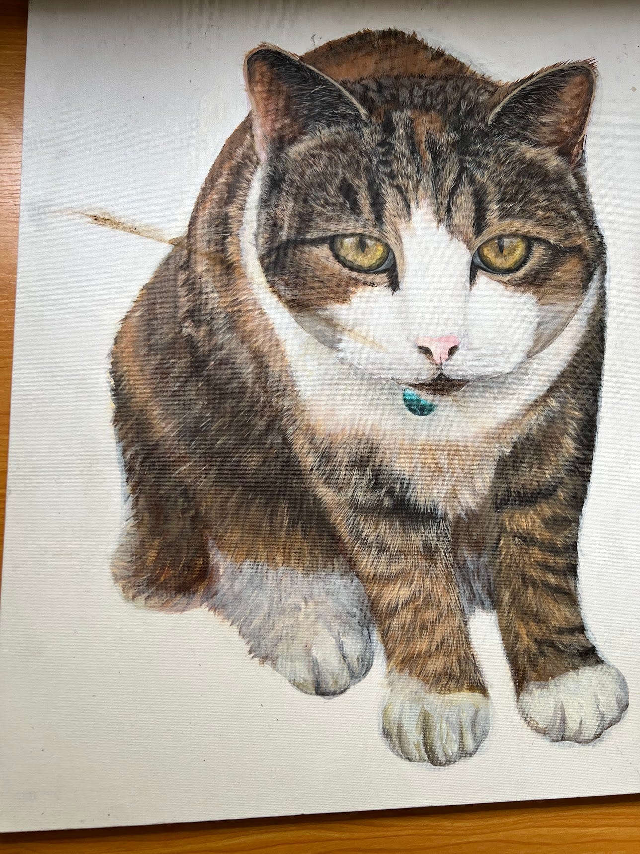 A photo of a painting of a cat with a smear of brown cat shit on it.
