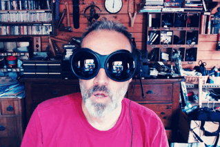 An animated GIF of myself in big black goggles, making rude gestures with my hands.