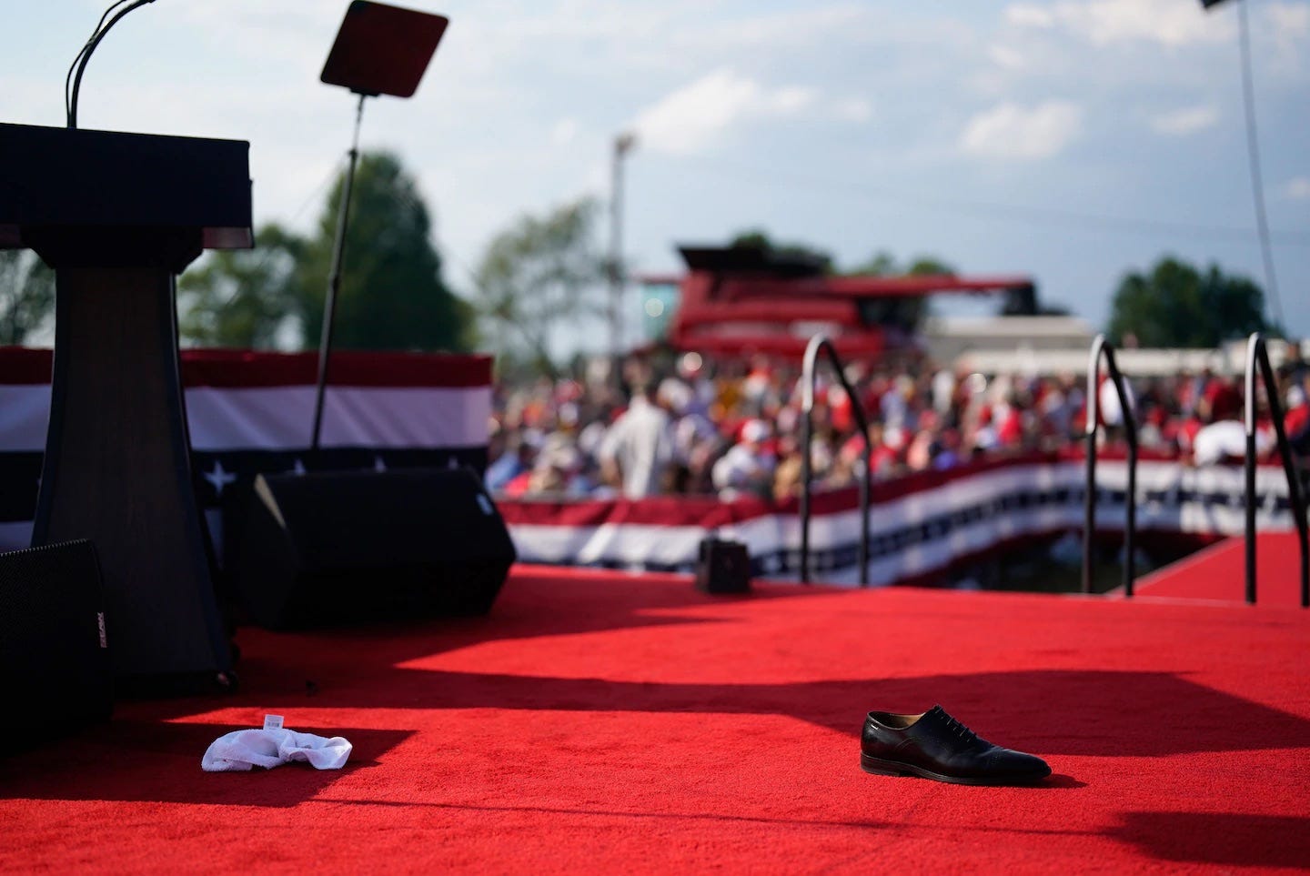 A shoe is left onstage after the shooting. Trump had asked for his shoes as he was rushed away. (Jabin Botsford/The Washington Post)