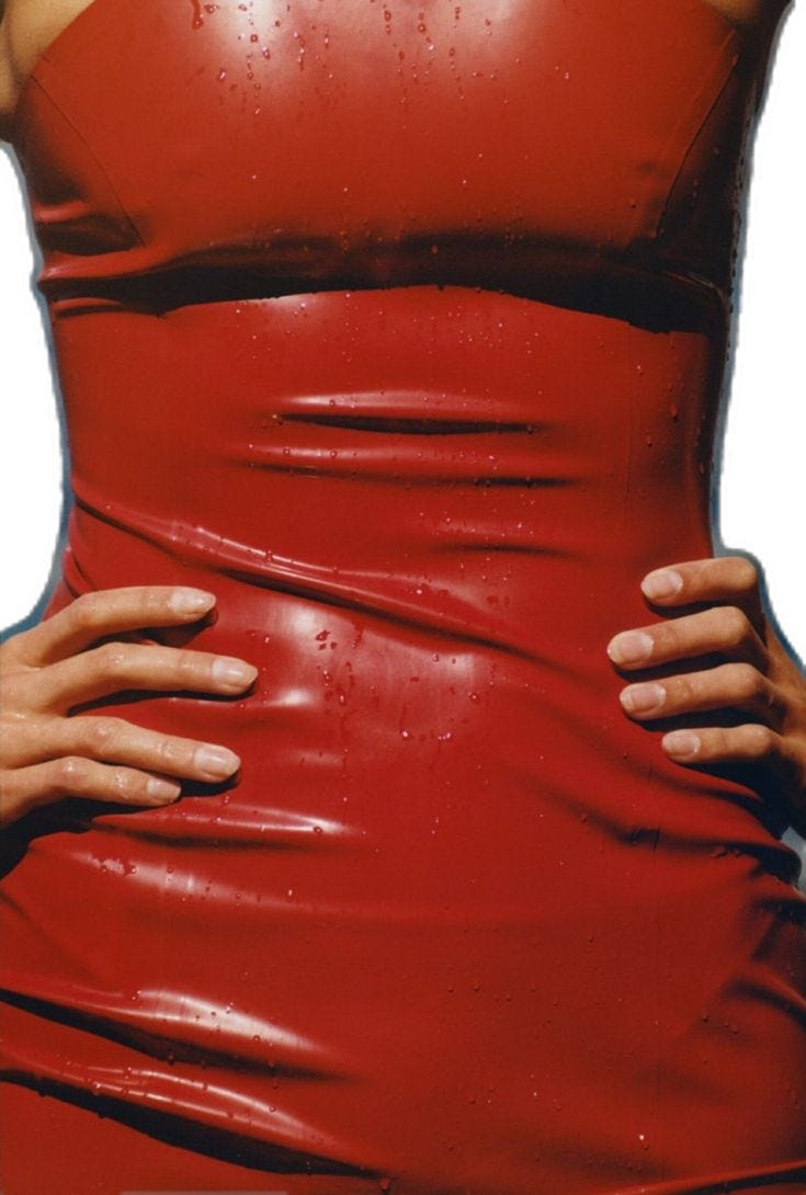 This may contain: a woman in a red leather dress with her hands on her hips and the back of her body