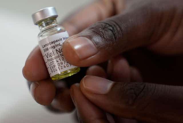 A clinician holds a vial of a drug called lenacapavir