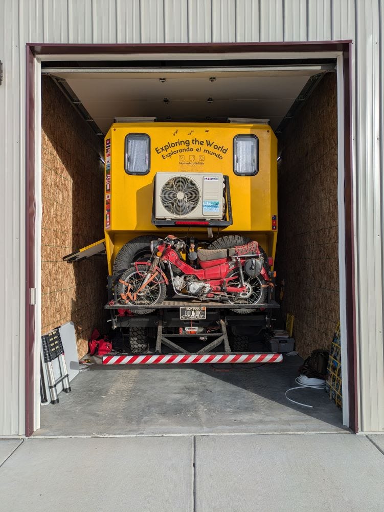 Walter the big yellow truck, parked in a narrow storage unit