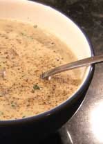 A small picture of a bowl of mushroom soup