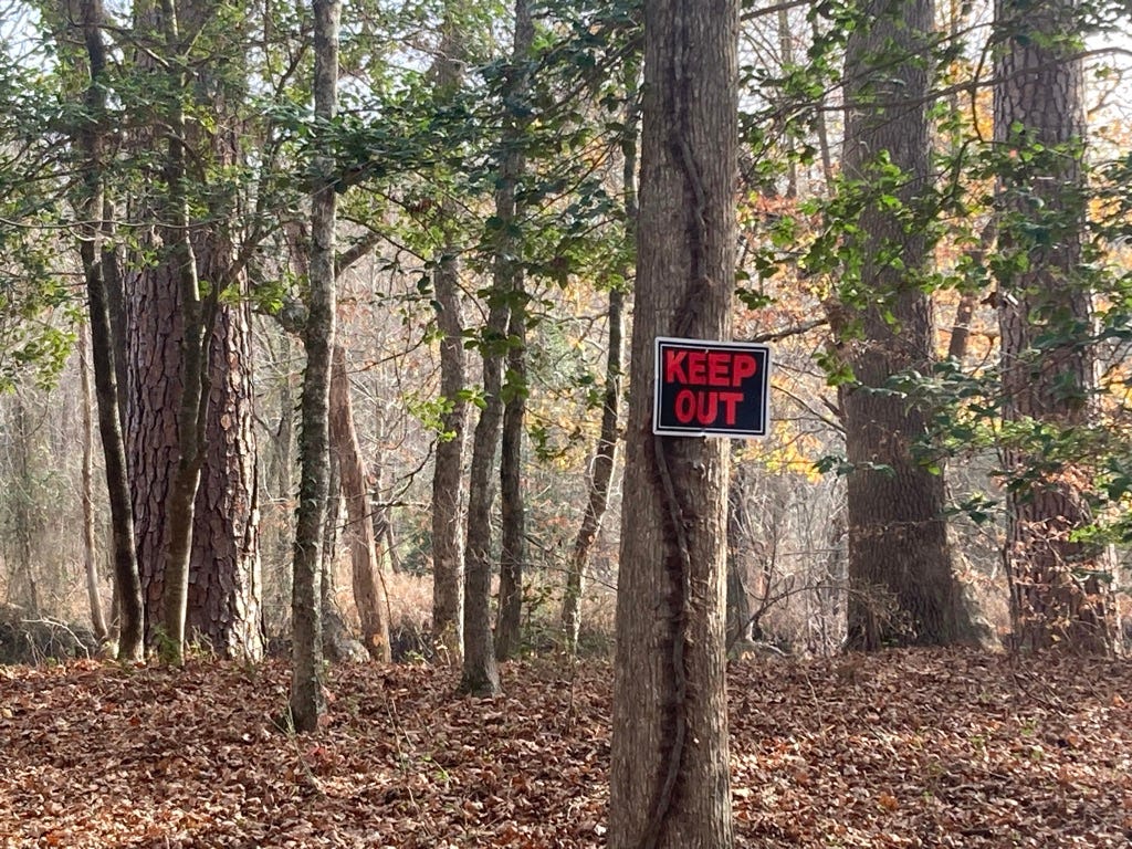 Keep Out sign on a tree