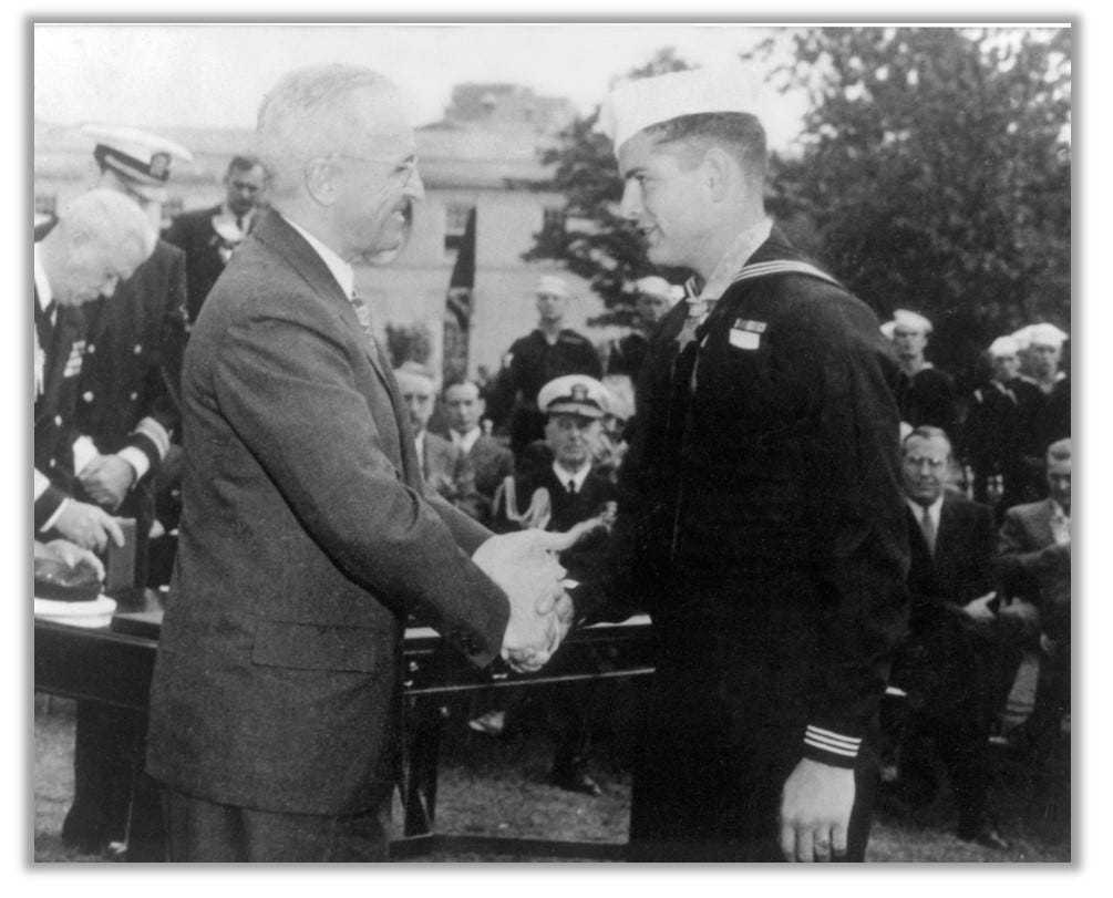 Bush shakes hands with Truman at his Medal ceremony.